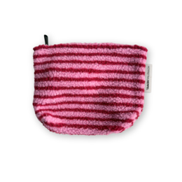 A plush, striped toiletry bag in shades of pink and red. The bag has a zipper closure and appears to be made of soft, fuzzy material.