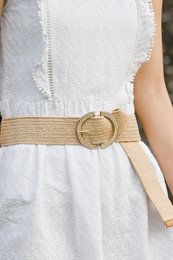  Woven straw belt with metal buckle, available in beige, ivory, and black colors.