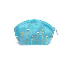 Turquoise cosmetic bag made of embroidered raw silk, featuring a pattern of golden candles. Suitable for weekend use.