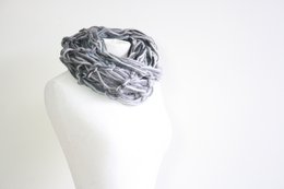 Dark green wool infinity scarf with a soft, textured knit pattern.