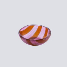 A round, shallow bowl with a magenta and orange striped pattern. The bowl appears to be made of glass or a similar material.