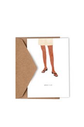 A birthday card featuring an illustration of a person's legs wearing red stockings. The card is titled "BREAK A LEG" and is from Studio KATHAN.