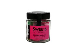 Assorted colorful bonbons in a glass jar labeled "Beerenauslese SWEETS by heidelbonbon". The bonbons appear to be round and have a variety of colors including pink, green, and white.