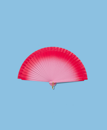 Vibrant red and white fan with a wooden handle, perfect for keeping cool on a hot summer day.