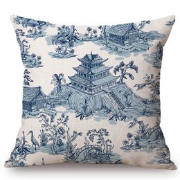 Decorative cushion with a Toile de Jouy pattern featuring a pagoda, flowers, and other Asian-inspired elements in shades of blue and white.