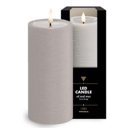 Tall, cylindrical sand-colored LED candle in a black box.