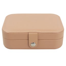 Large tan jewelry box with a rectangular shape, a clasp closure, and a soft interior for storing jewelry.