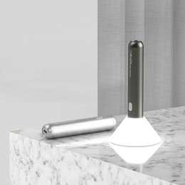  Rechargeable flashlight/nightlight with cylindrical metal body and white light-emitting head, suitable for use as a table lamp.