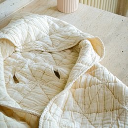  Soft, cozy natural hooded baby blanket made of high-quality materials for comfort and warmth.