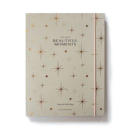 A cream-colored notebook with a starry night sky pattern and the text "Collect beautiful moments" printed on the cover.