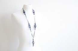Medium-sized blue necklace with delicate floral charms.