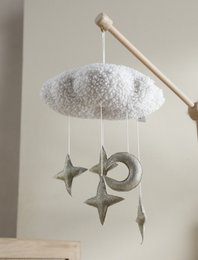 Soft, fluffy white cloud-shaped mobile with metallic gold star and moon accents. Ideal for soothing and entertaining babies.