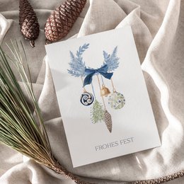 Blue birds, white bells, botanical leaves, festive Christmas card, cream textured paper, elegant holiday greeting.