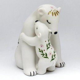 A white ceramic polar bear night light with a floral design, suitable for a child's bedroom.