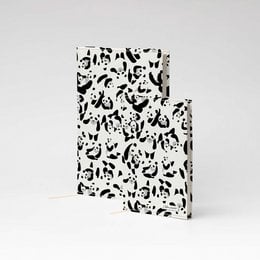 A5 and A6 sized notebook with a patterned cover featuring various panda illustrations in black and white. The notebook is made of Tyvek material.