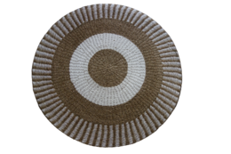 A round, woven seagrass rug with a neutral color palette of beige, brown, and white. The rug features a circular pattern with concentric rings of varying textures and shades, creating a bohemian, natural aesthetic.