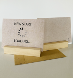 Greeting card with "NEW START" text and a loading icon, indicating a new beginning or fresh start.