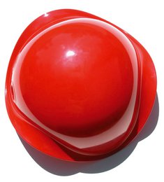 A round, red, plastic sensory toy with a smooth, glossy surface and a unique, ergonomic shape that encourages tactile exploration and sensory stimulation.