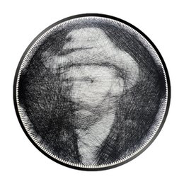 Round black and white abstract wall art with textured patterns.