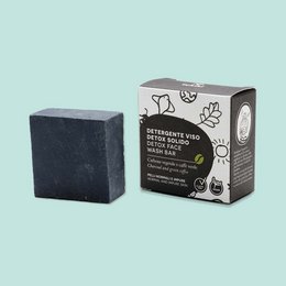 A black, square-shaped solid face cleanser made of natural ingredients for detoxifying the skin.