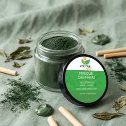 A green clay and spirulina face mask in a glass jar, designed to help with blemishes and skin impurities. The mask is made with natural ingredients and is available in various sizes.