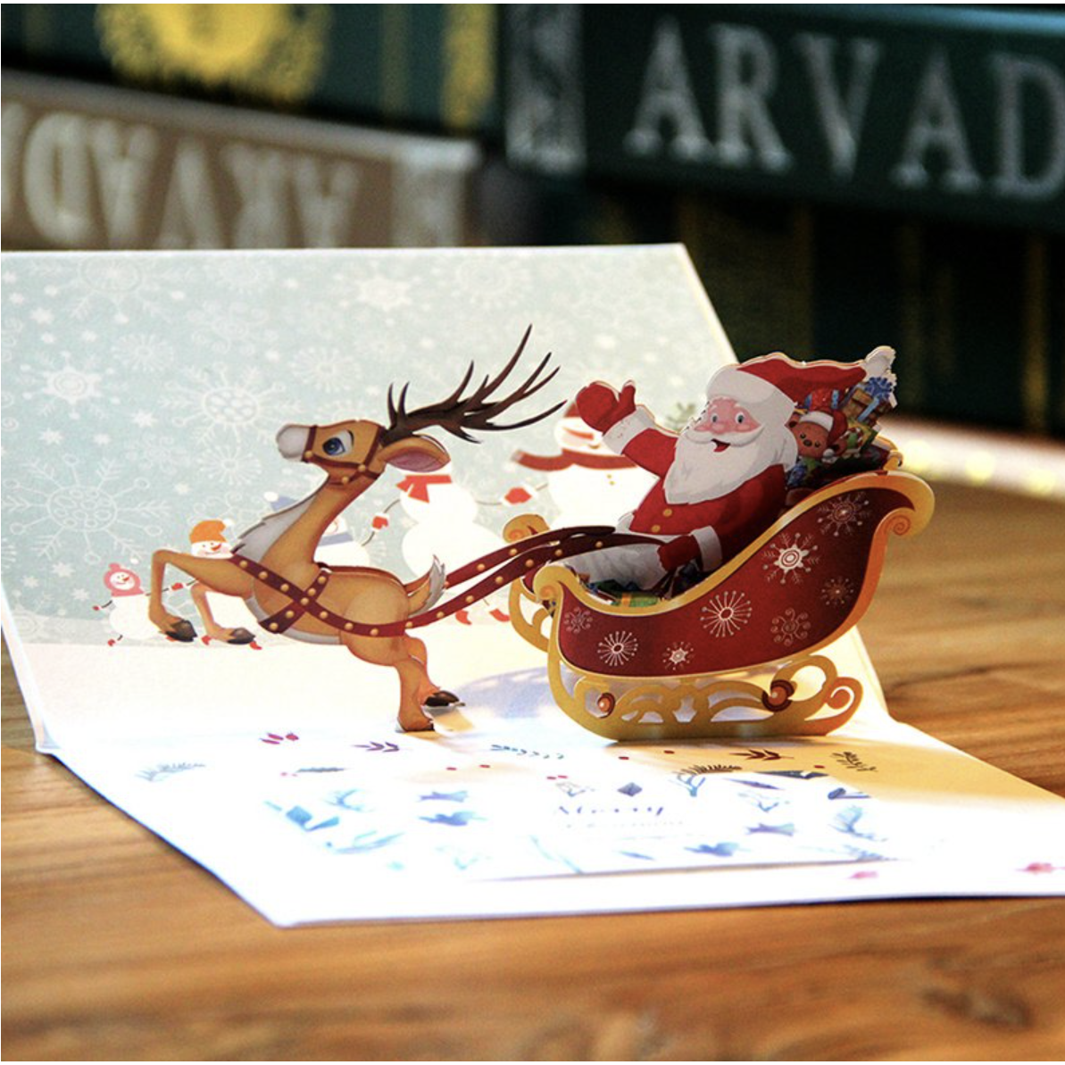 Tarjeta de Navidad emergente 3D Feliz Papá Noel en un trineo con renos