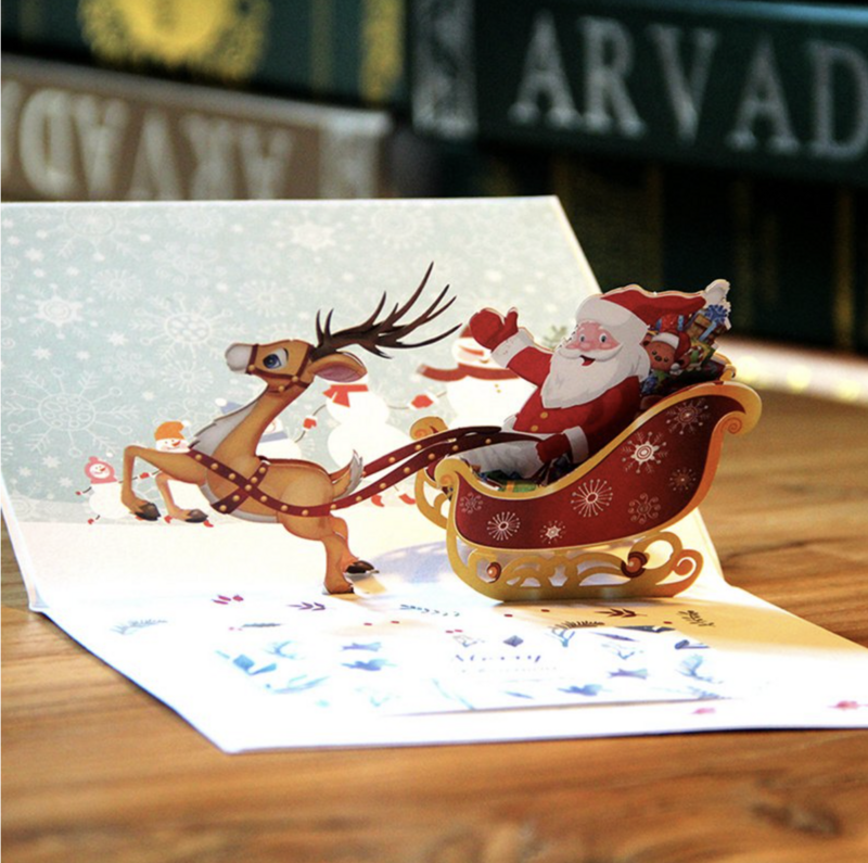 3D pop up Christmas card Merry Santa on a sleigh with reindeer