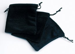 Black velvet jewelry box with drawstring closure.