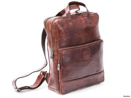 A brown leather backpack with multiple compartments and a sleek, minimalist design. The backpack features a durable construction, adjustable straps, and a spacious interior suitable for everyday use or travel.