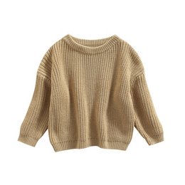 Cozy, beige knitted baby sweater with a ribbed texture and loose, oversized fit.
