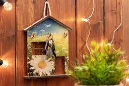  "Wooden house-shaped key holder with flower field design, daisy motif, rustic wall decor"