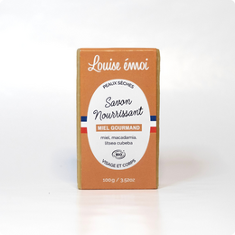 Savon Moussant (100g) - Honey-scented soap bar with natural ingredients.
The product is a honey-scented soap bar from the brand Louise Émoi. The soap bar is made with natural ingredients and has a rectangular shape. The packaging is orange in color and displays the product name and brand name prominently.