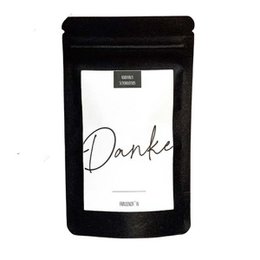A small, black package with the word "Danke" written in cursive on a white background. The package appears to be a chocolate gift or similar product.