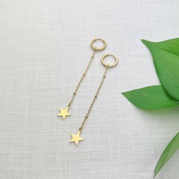 Gold-toned star-shaped charms on delicate chains. Elegant and minimalist jewelry piece.