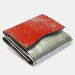 Compact wallet made of paper material in a silver color with a minimalist design.
