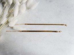 Thin gold-colored chain bracelet with delicate design.