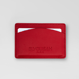 Red leather card holder with embossed 'EVOLUSH PARIS' branding. Compact and minimalist design suitable for storing credit cards, ID, and other small items.