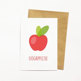 A red apple with green leaves and the text "Oogappeltje" on a greeting card.