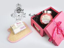 Fuchsia luxury gift box with magnolia scented products, including a candle and bath products, packaged in a decorative pink box with a bow.
