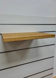 Wooden wall-mounted shelves for pet toys, featuring a simple, minimalist design with natural wood tones.