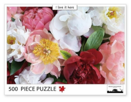 A 500-piece jigsaw puzzle featuring a vibrant floral arrangement with pink, white, and red peonies. The puzzle showcases a variety of blooming flowers in a lush, natural setting.