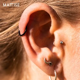 Black surgical steel ring piercing, suitable for helix, tragus, septum, lip, nose, and eyebrow piercings. Available in 6mm, 8mm, 10mm, and 12mm diameters with 1.0mm or 1.2mm thickness.