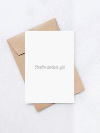A white greeting card with the text "Crafts make me happy" printed on it, sitting on a brown envelope.