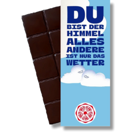 Dark chocolate bar with text "Du bist der Himmel alles andere ist nur das Wetter" (You are the sky, everything else is just the weather) and a snowflake icon.