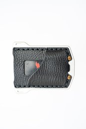 Black leather wallet with textured pattern and metal accent. Compact design suitable for everyday use.