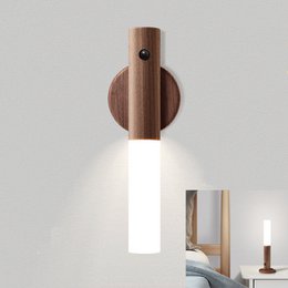 Wooden LED desk lamp with round shape and minimalist design, available in coffee and white color variants.