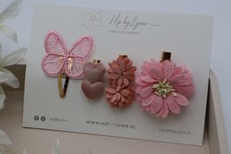 Set of 3 decorative hair clips featuring a pink butterfly, a pink flower, and a brown flower.