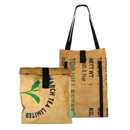 A large, beige backpack-style shopper bag made from recycled materials. The bag has a green leaf logo and the text "March for the planet" printed on the front.