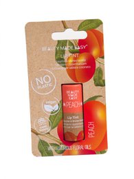 Tinted lip balm in peach color, made with natural ingredients, moisturizing and nourishing for the lips.