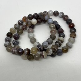 Botswana agate lithotherapy bracelet, available in sizes 13 cm to 18 cm, featuring natural multicolored agate beads with a variety of patterns and shades.